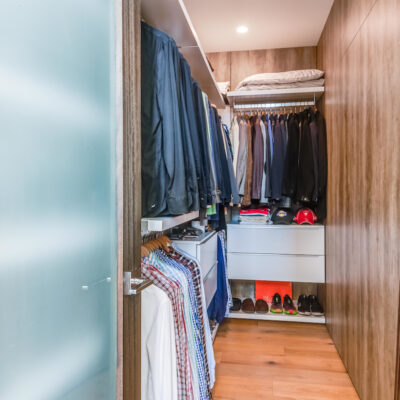 Sophisticated primary walk-in closet